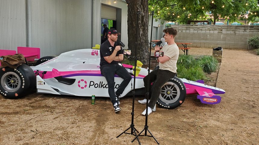 Conor Daly signing autographs at the Polkadot booth at Consensus 2024