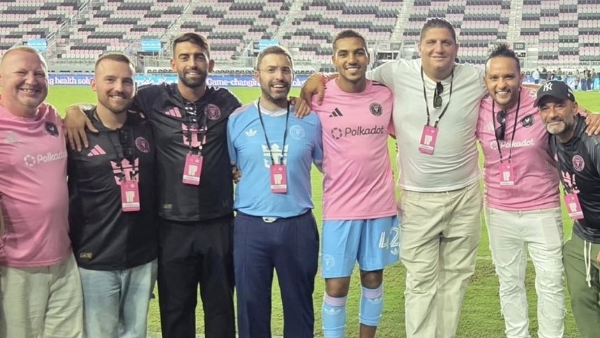 The Polkadot group on the pitch with Inter Miami CF players at Chase Stadium